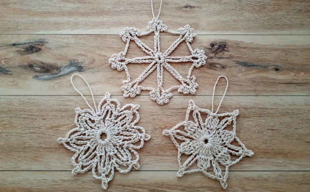 three crocheted snowflake patterns
