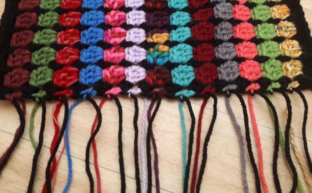 how to crochet a pocket shawl using scrap yarn
